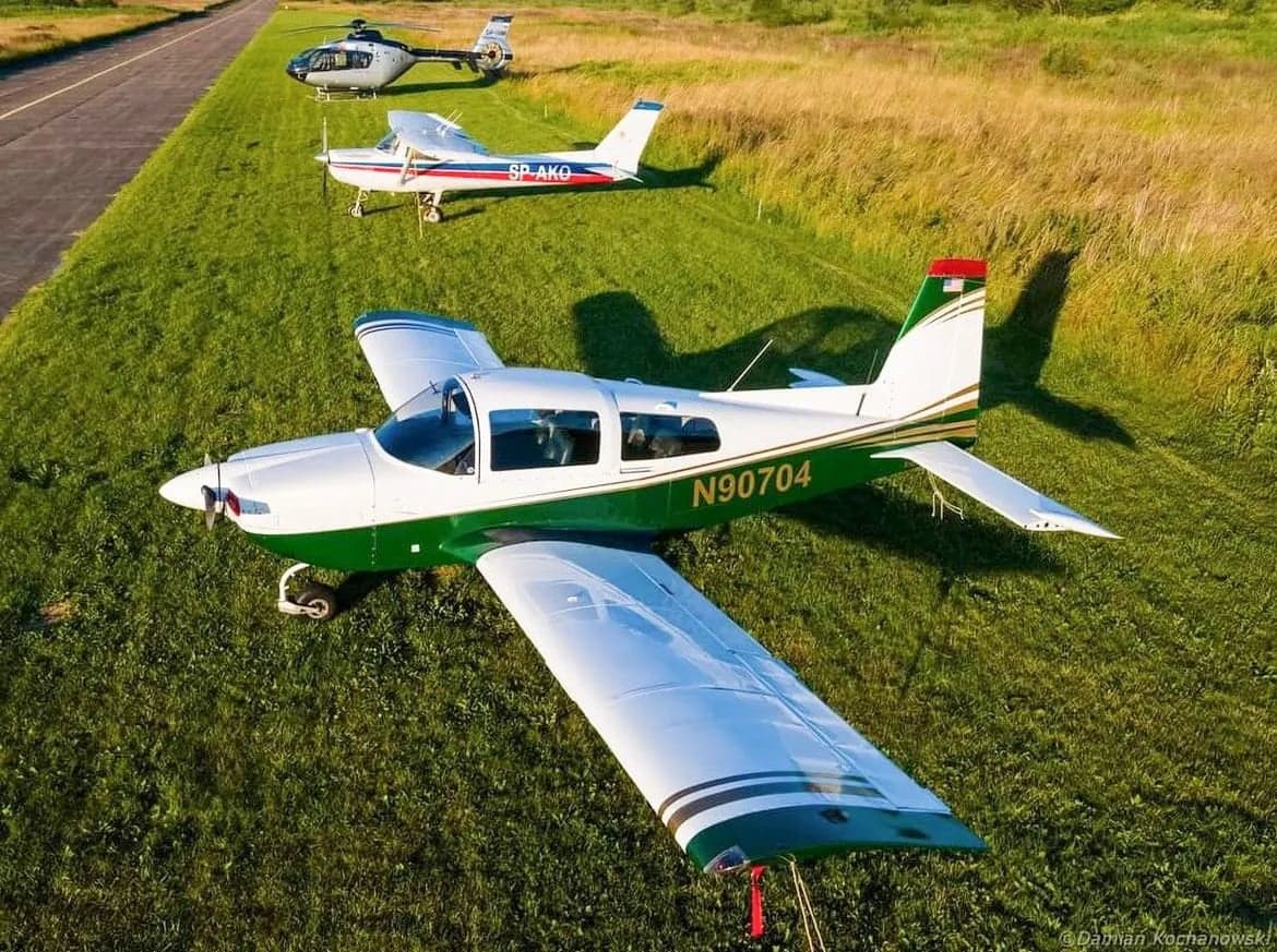 Aerial view of N90704 aircraft on the grass.