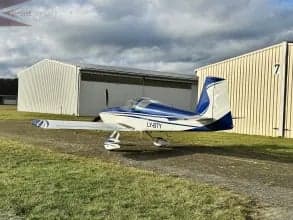 A blue and white aircraft with registration LY-BTY is parked on the ground.