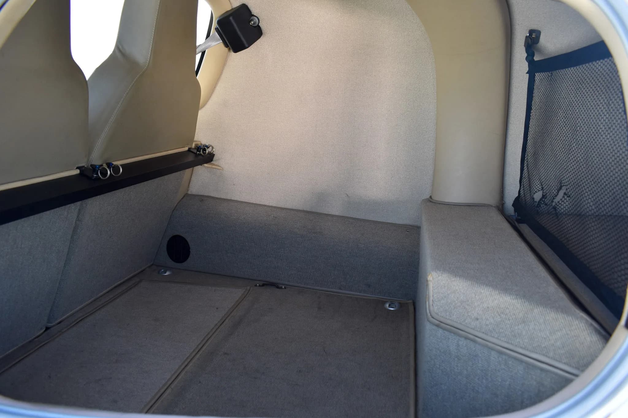 Interior view of the rear cargo or storage area of the aircraft cabin.