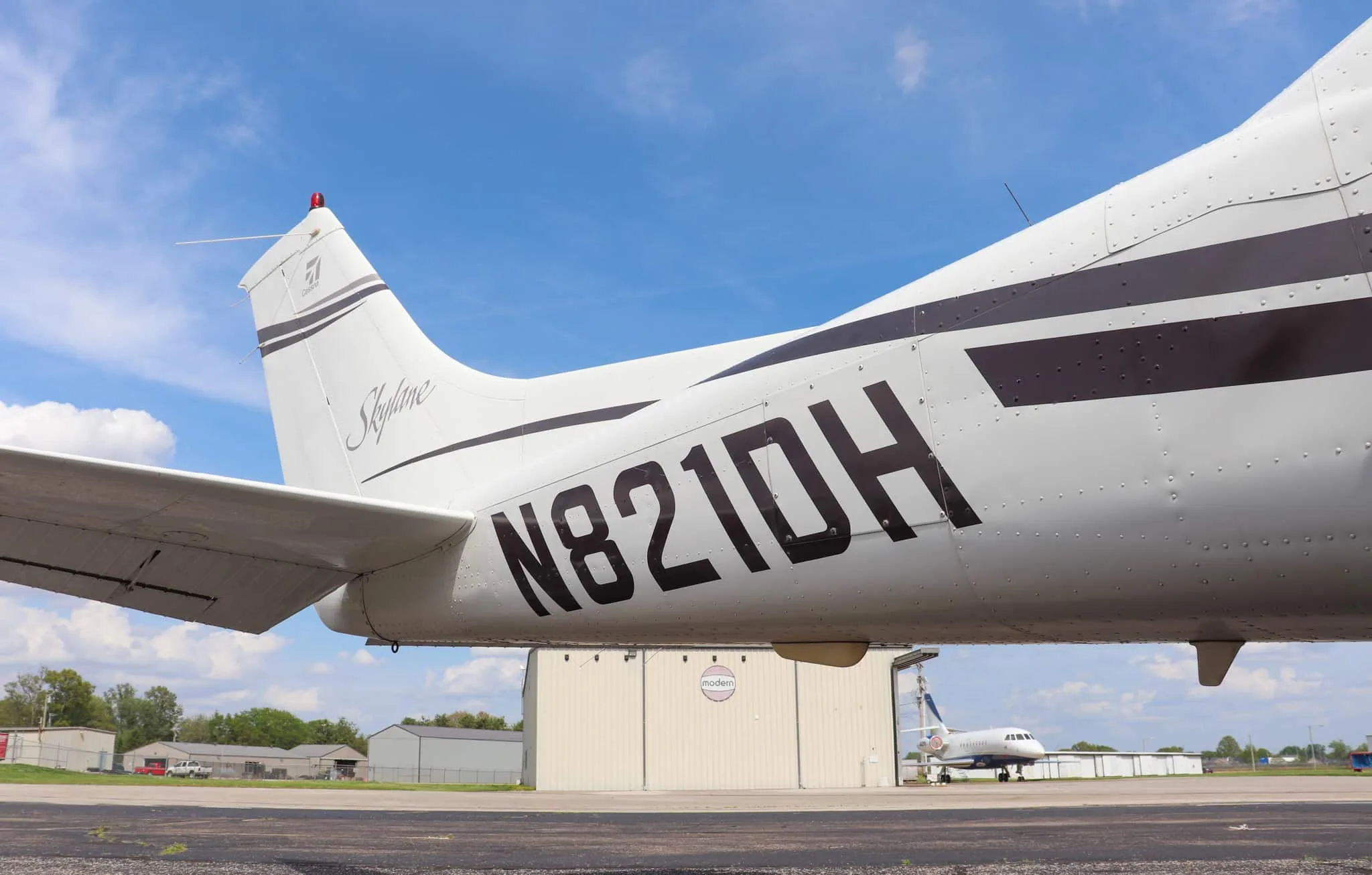 A close-up of the tail section of the Cessna Skylane N821DH, showing the registration number and "Skylane" script.