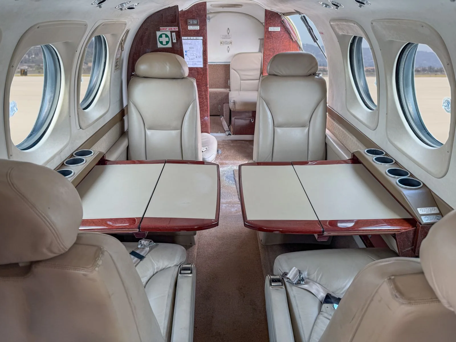 Interior view of the King Air cabin with leather seats and tables.