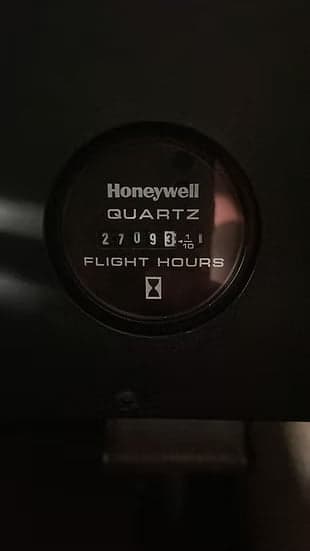 Close-up of the Honeywell Quartz flight hours meter in the cockpit.