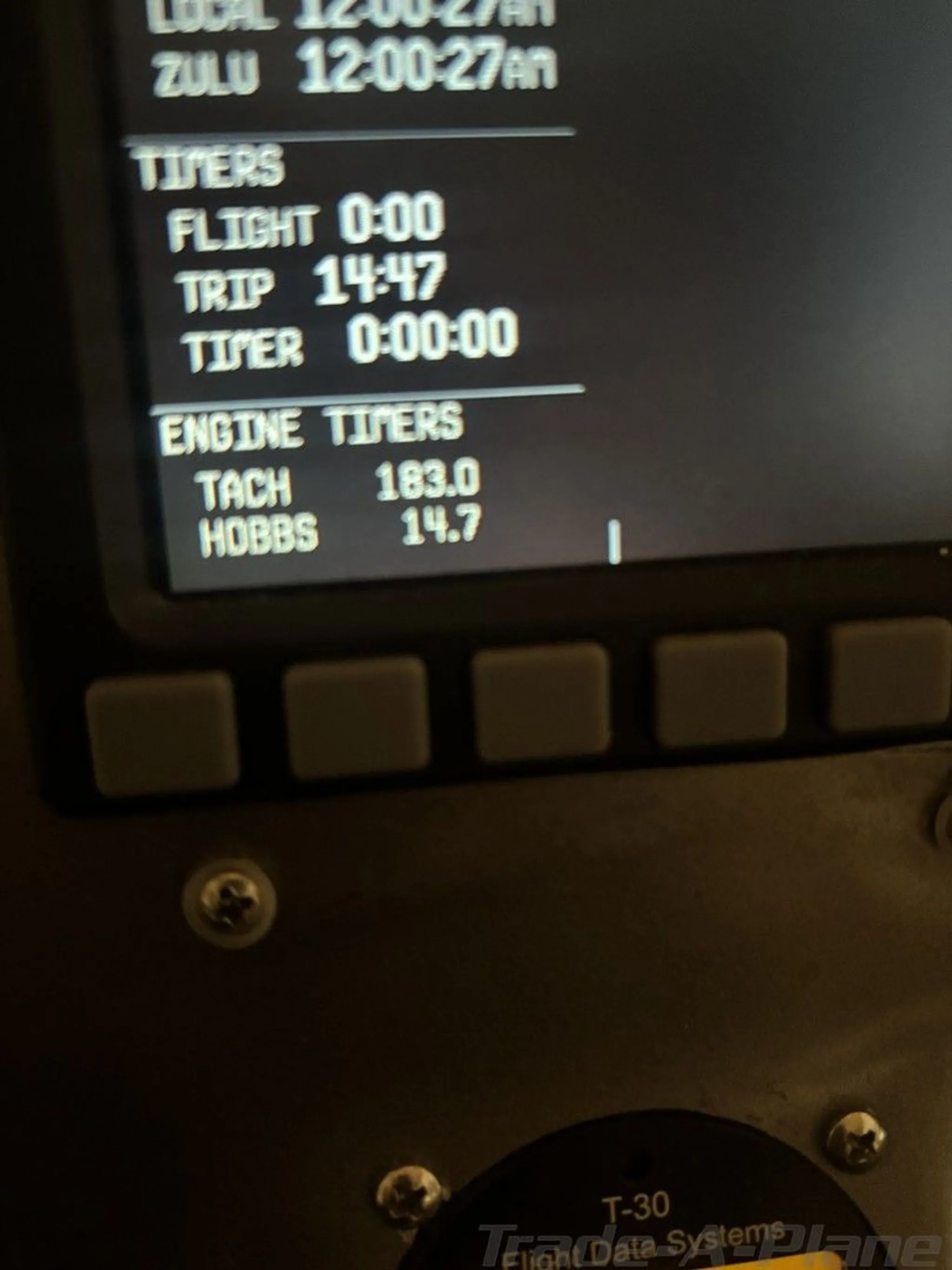 A close-up of a digital display showing flight timers and engine hours (Tach 183.0, Hobbs 14.7).