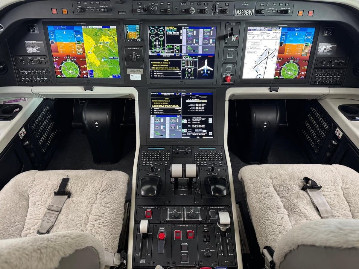 View of the aircraft's cockpit with instrument panel and seats.