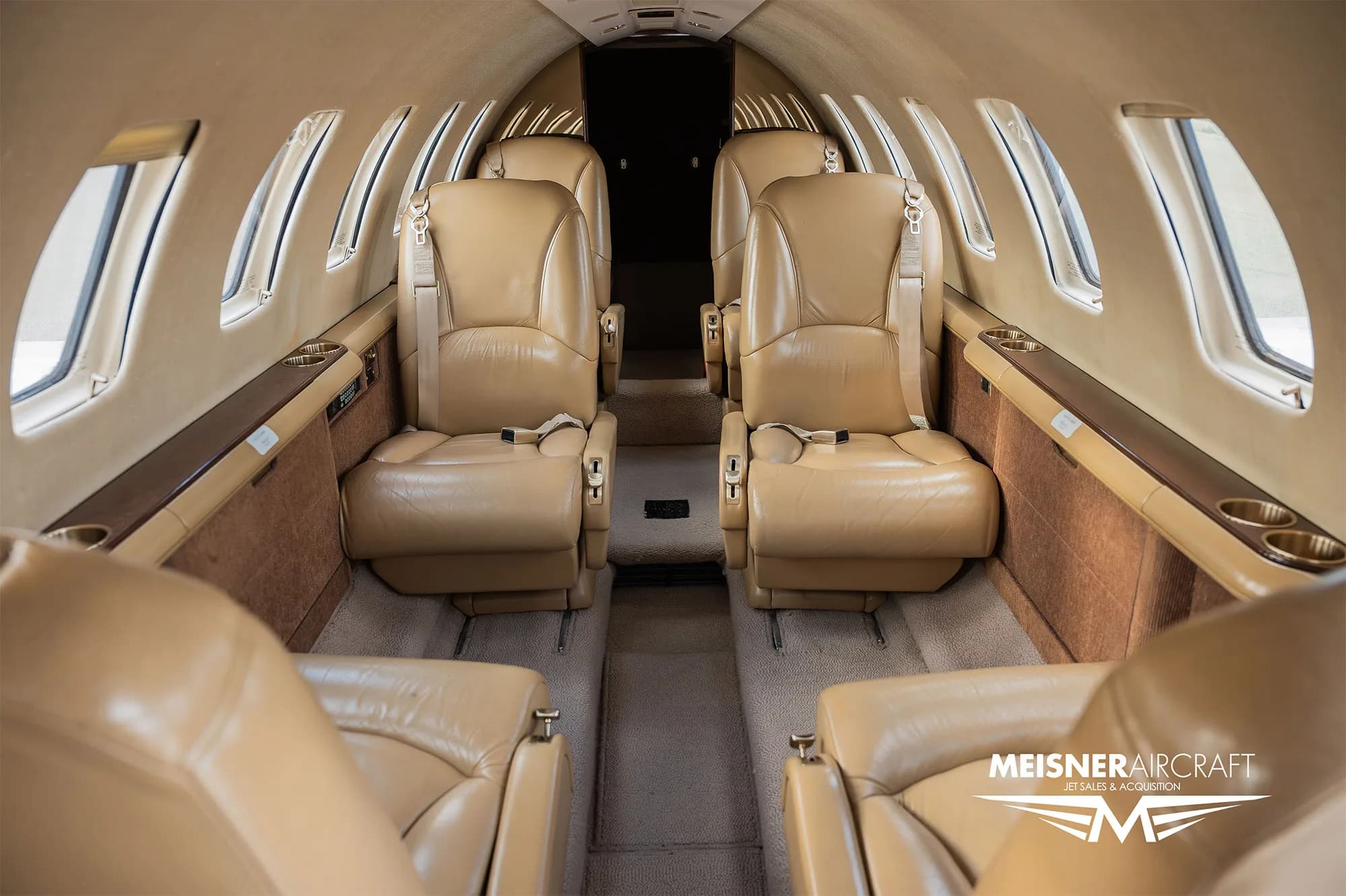 Interior view of a Cessna Citation Encore with tan leather seats.