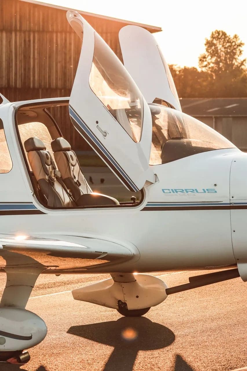 Close up of Cirrus SR22 aircraft N133CD with doors open.