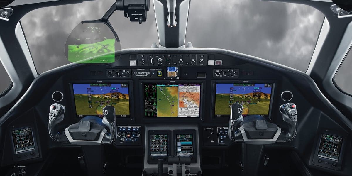The cockpit of an aircraft with multiple display screens.