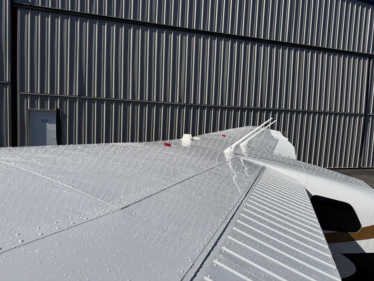 Close-up of the aircraft wing with water droplets.