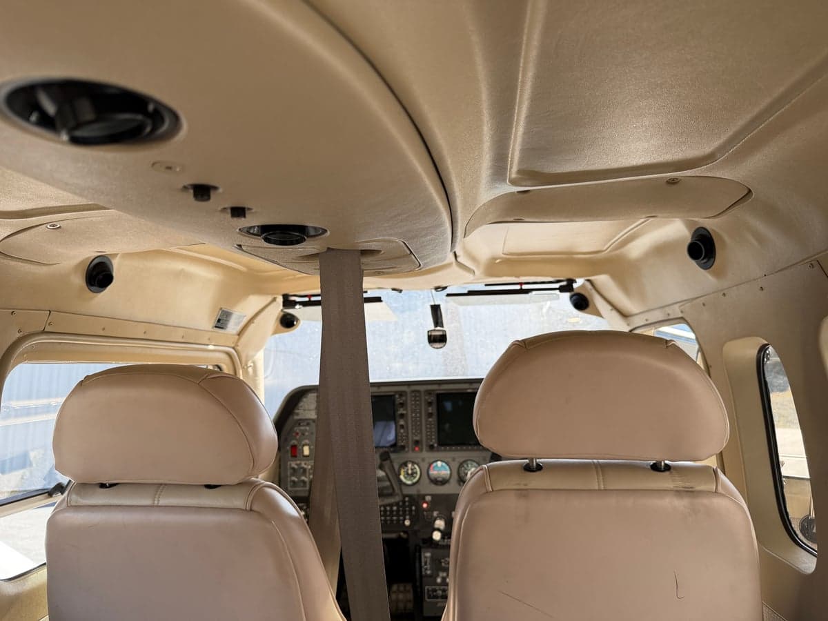 View of the aircraft's interior ceiling and front seats.
