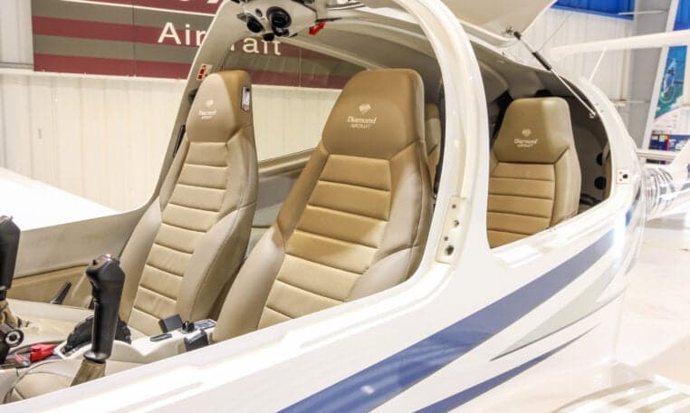 The interior of a Diamond DA40 aircraft features tan leather seats.