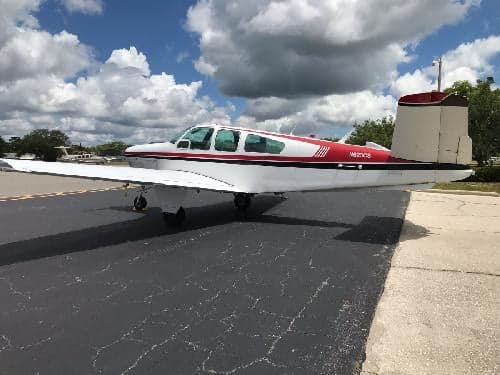 A Beechcraft Bonanza with registration N623CS is parked on the tarmac.