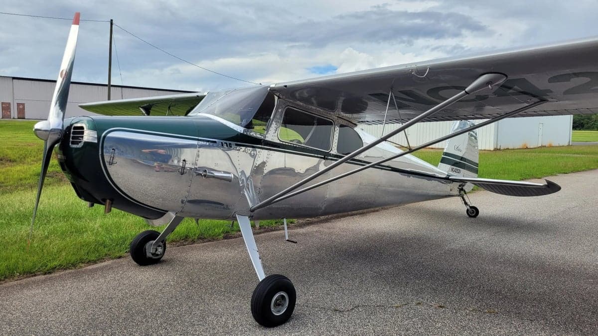 A Cessna 170 aircraft is parked on the tarmac.
