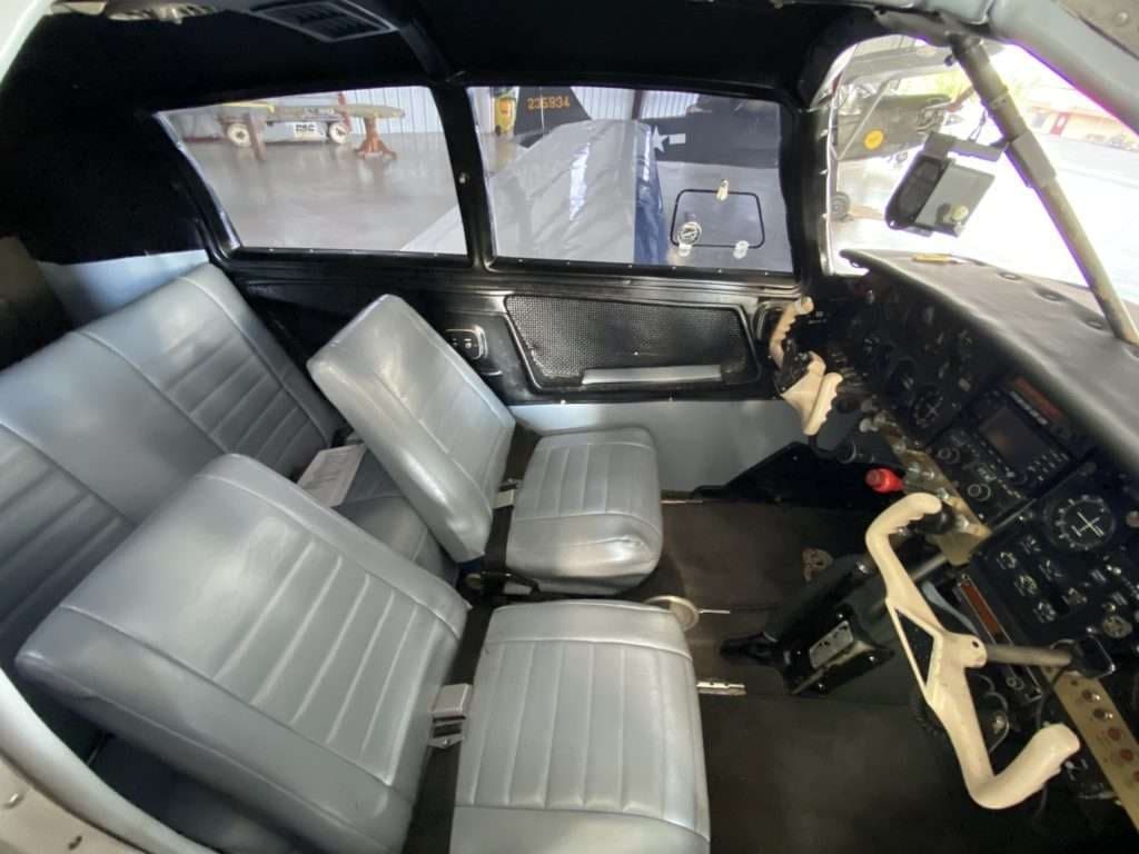 The interior of the Mooney M20C aircraft, showing the seats and instrument panel.