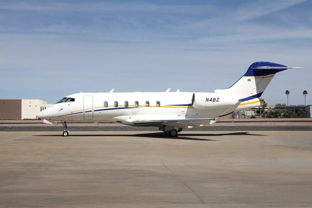 Side view of the N4BZ aircraft on the tarmac with a white and blue paint scheme.