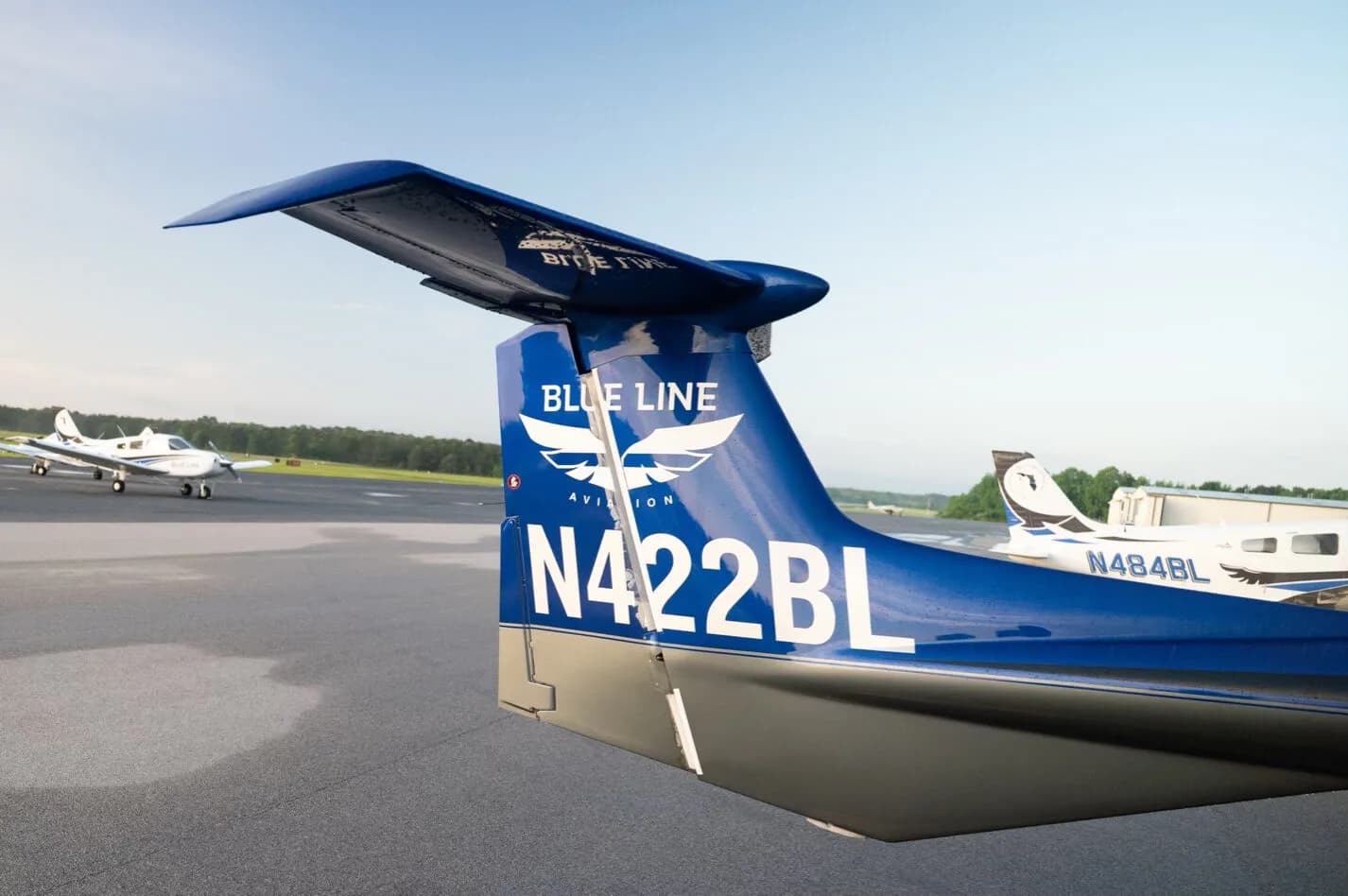 Close-up rear view of the blue tail of the Diamond DA42NG aircraft, N422BL, with "Blue Line Aviation" logo.