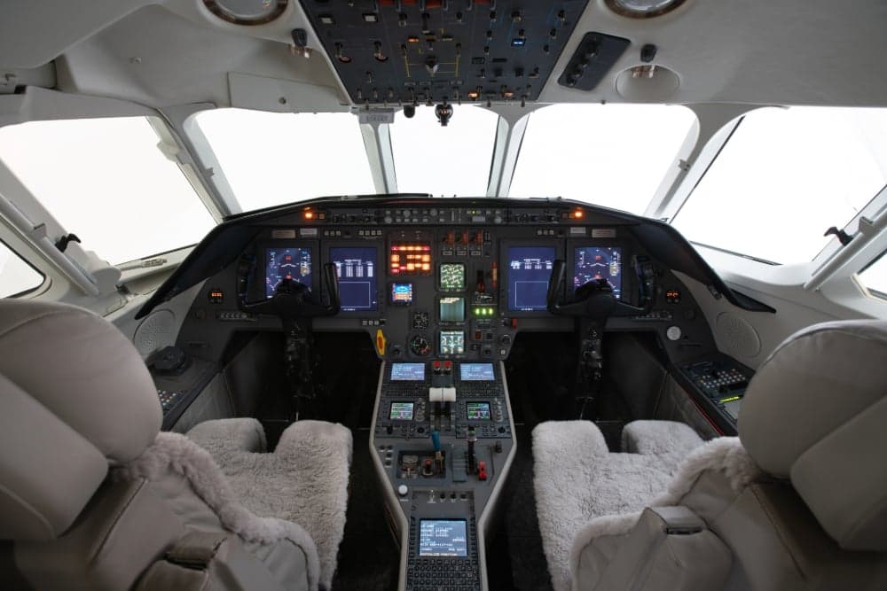 View of the aircraft cockpit with sheepskin seat covers.