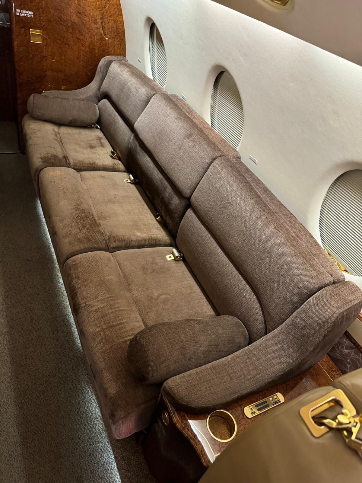 A view of the aircraft cabin seating with brown upholstery.