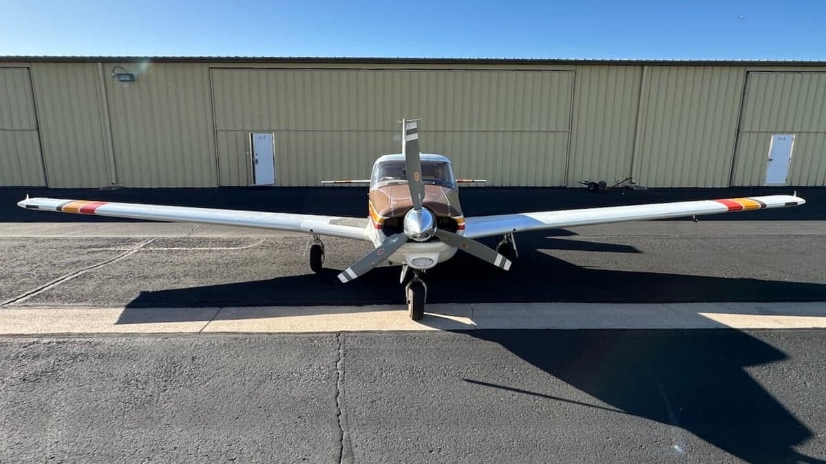 Front view of a Piper PA-28-181 Archer II aircraft on the tarmac.