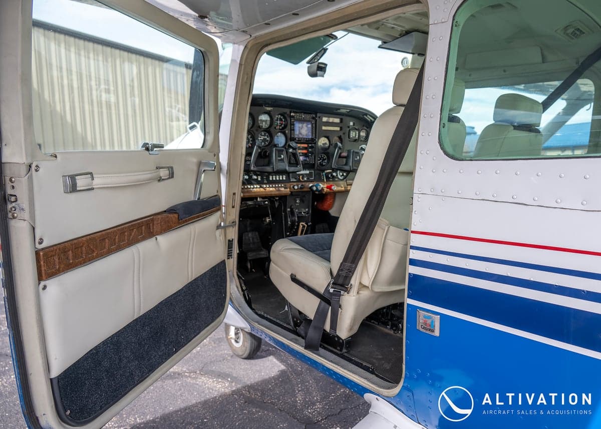 The interior of a Cessna aircraft, featuring seats with a two-tone color scheme.