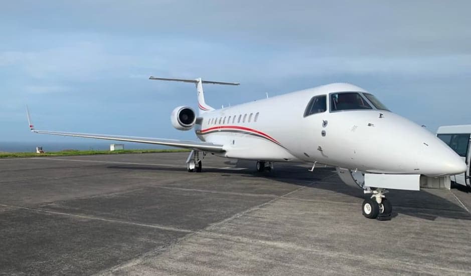 Embraer Legacy aircraft parked on the tarmac.