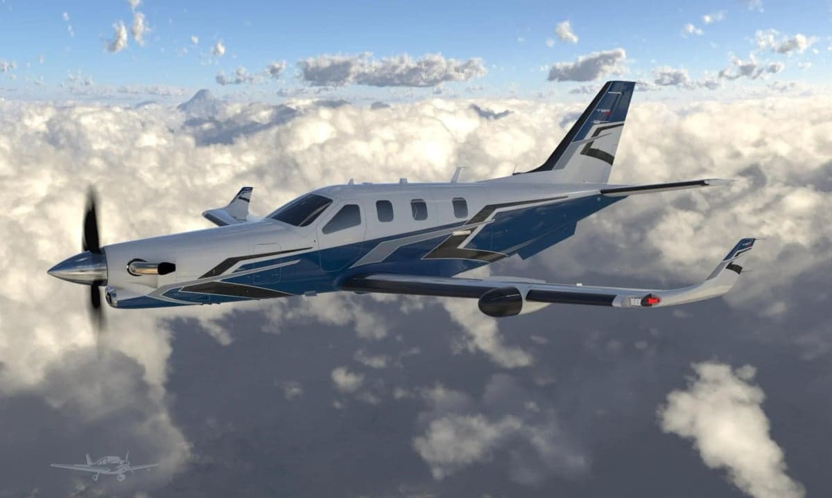 A blue and white TBM turboprop aircraft flying above the clouds.
