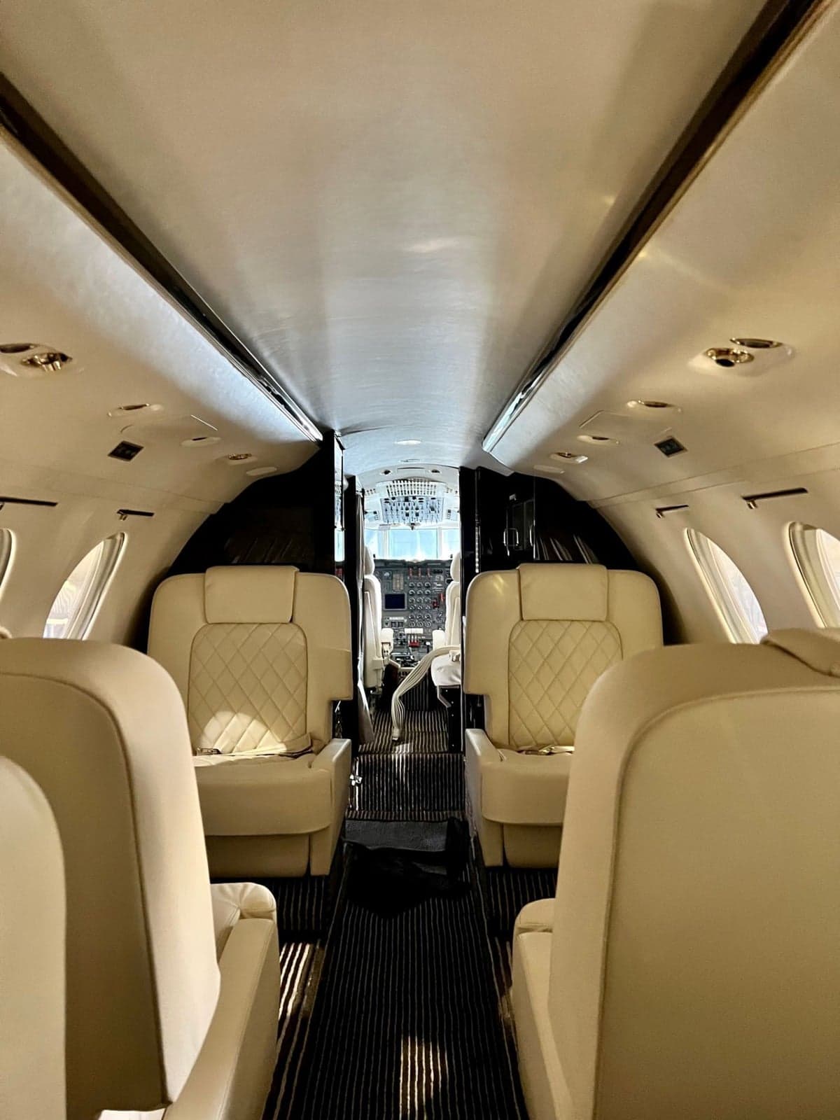 The cockpit of a Dassault Falcon 900 features dual flight controls and a full instrument panel.