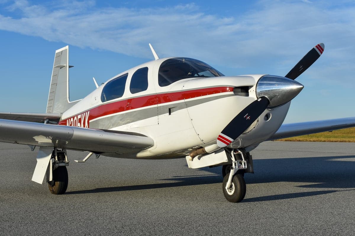 Side view of the N205KK aircraft on the tarmac.