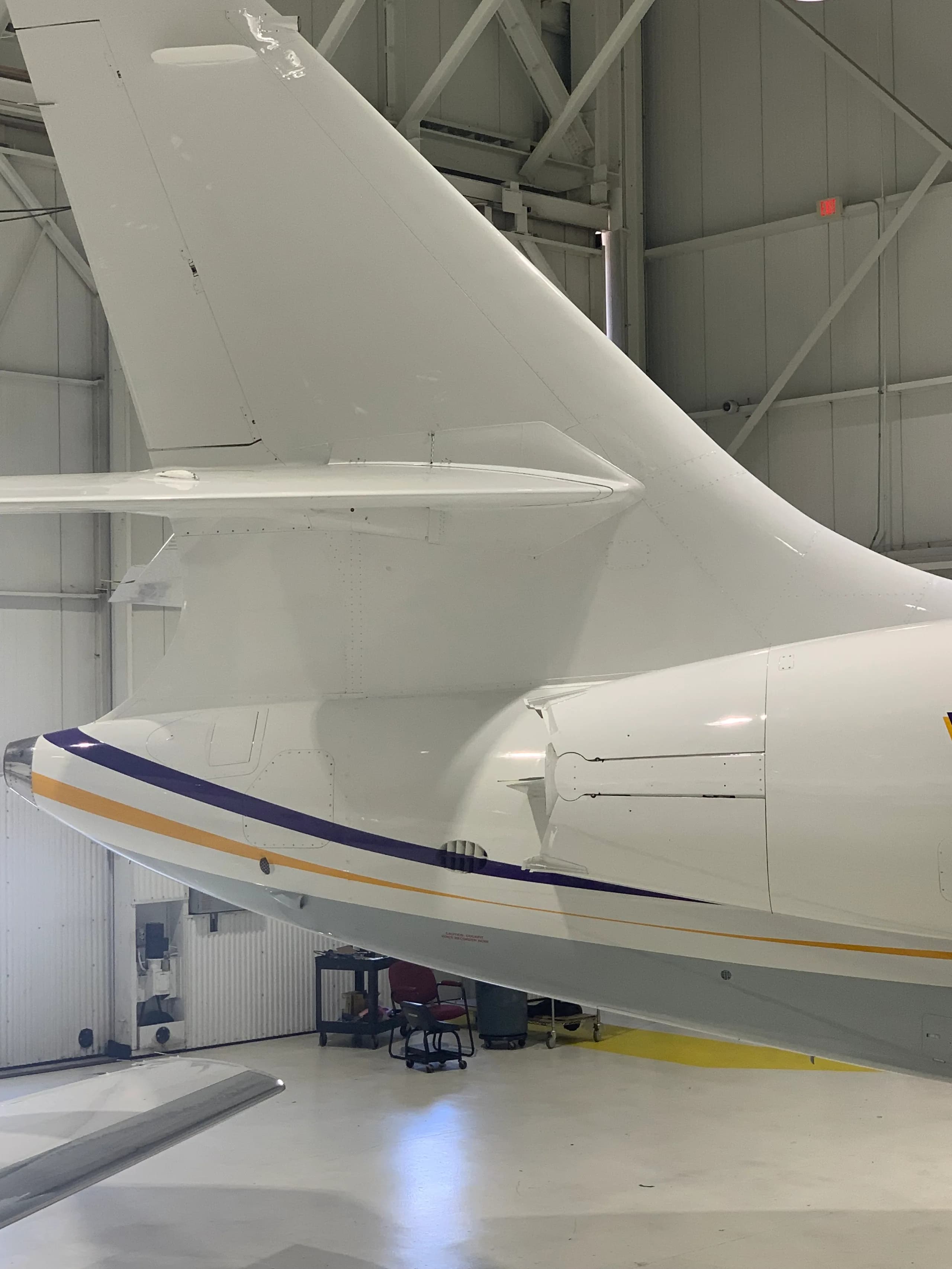 Close-up of the tail section of the aircraft in a hangar.