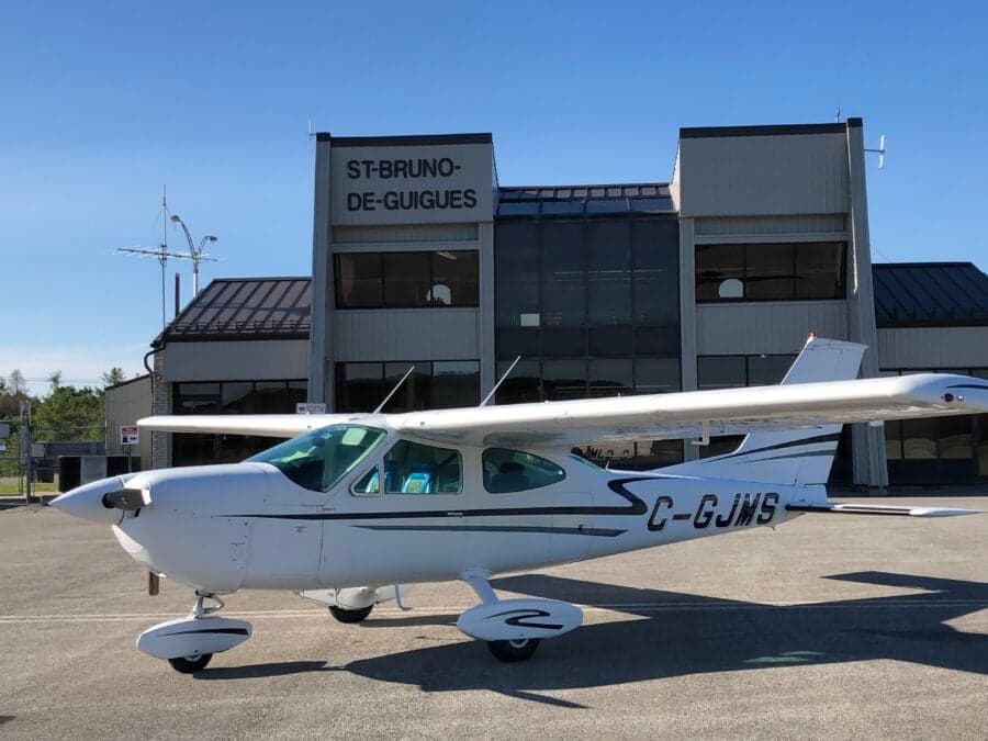 C-GJMS Cessna Cardinal 177 parked in front of the St-Bruno-De-Guigues building.