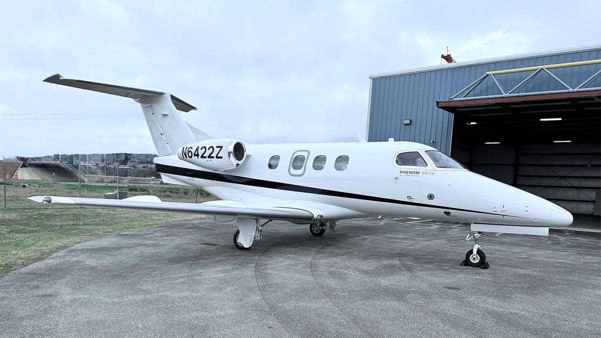 N6422Z Phenom 300E on the ramp in front of a hangar.