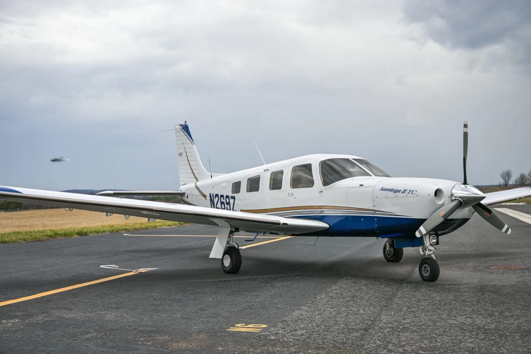 A three-quarter front view of a white Piper Saratoga II TC aircraft, tail number N269Z, parked on an airport tarmac.