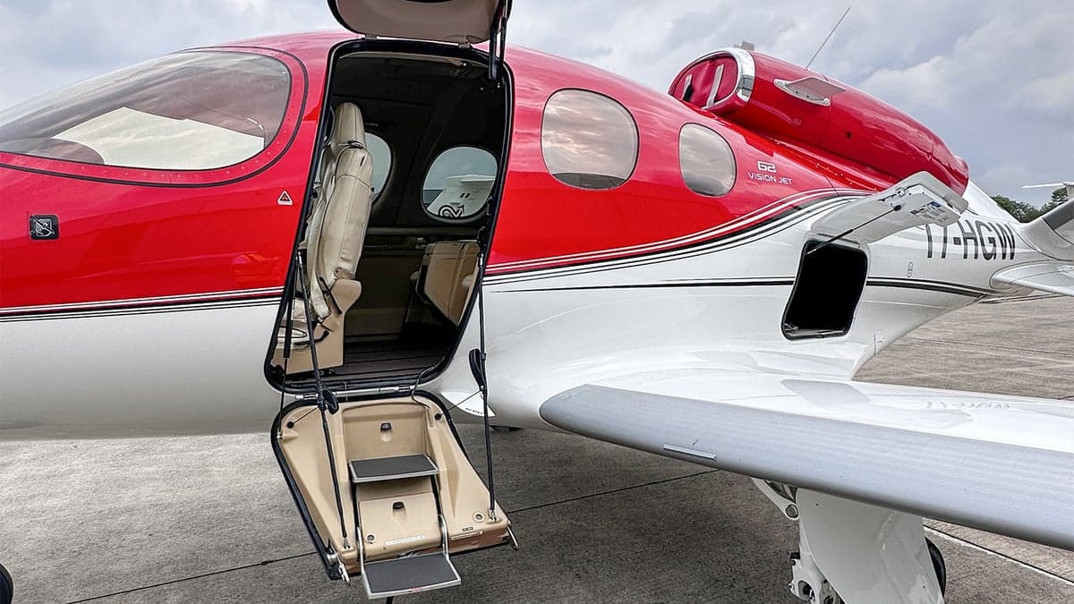 A Cirrus Vision Jet with the door open, showing the entry steps.