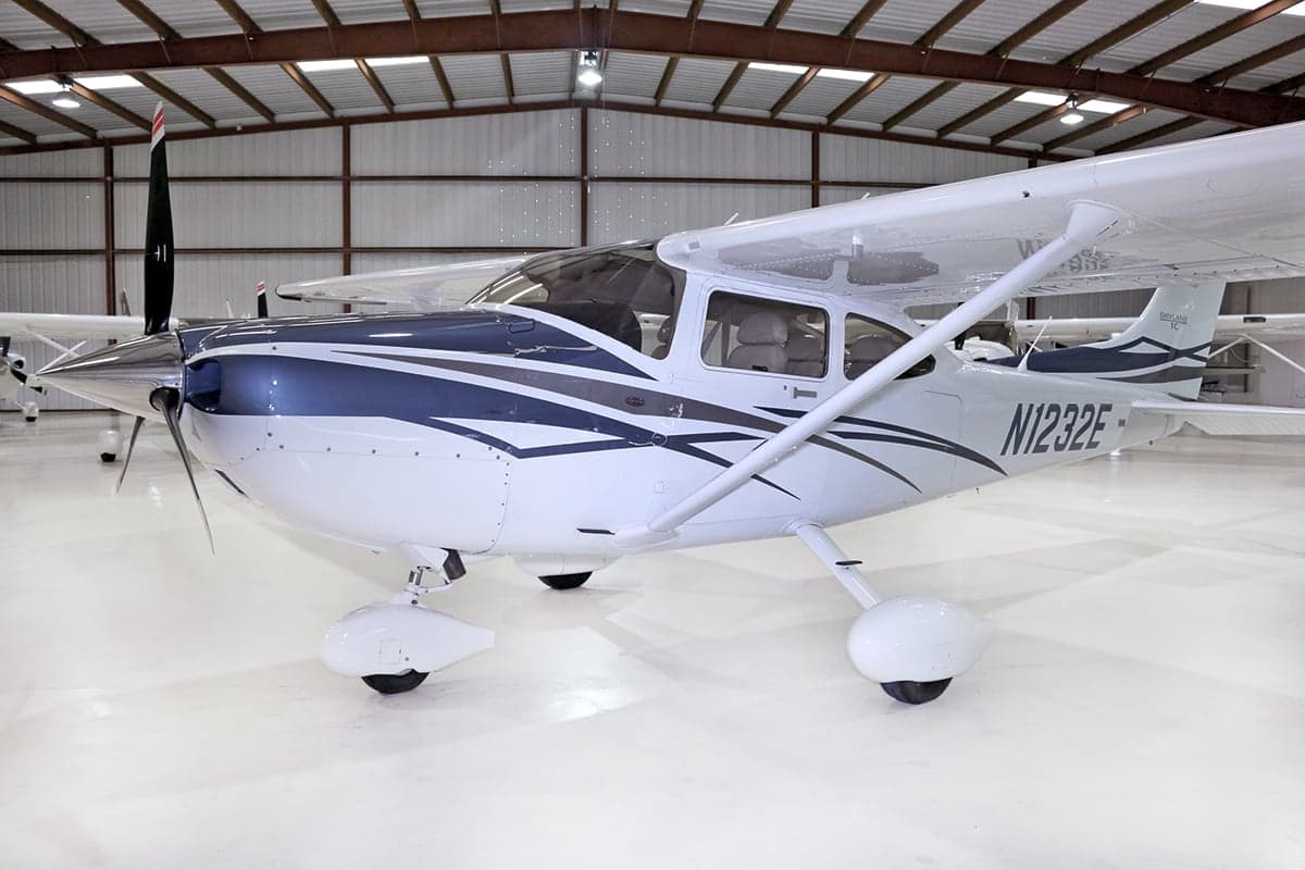 A Cessna Skylane TC aircraft with registration N1232E parked in a hangar.