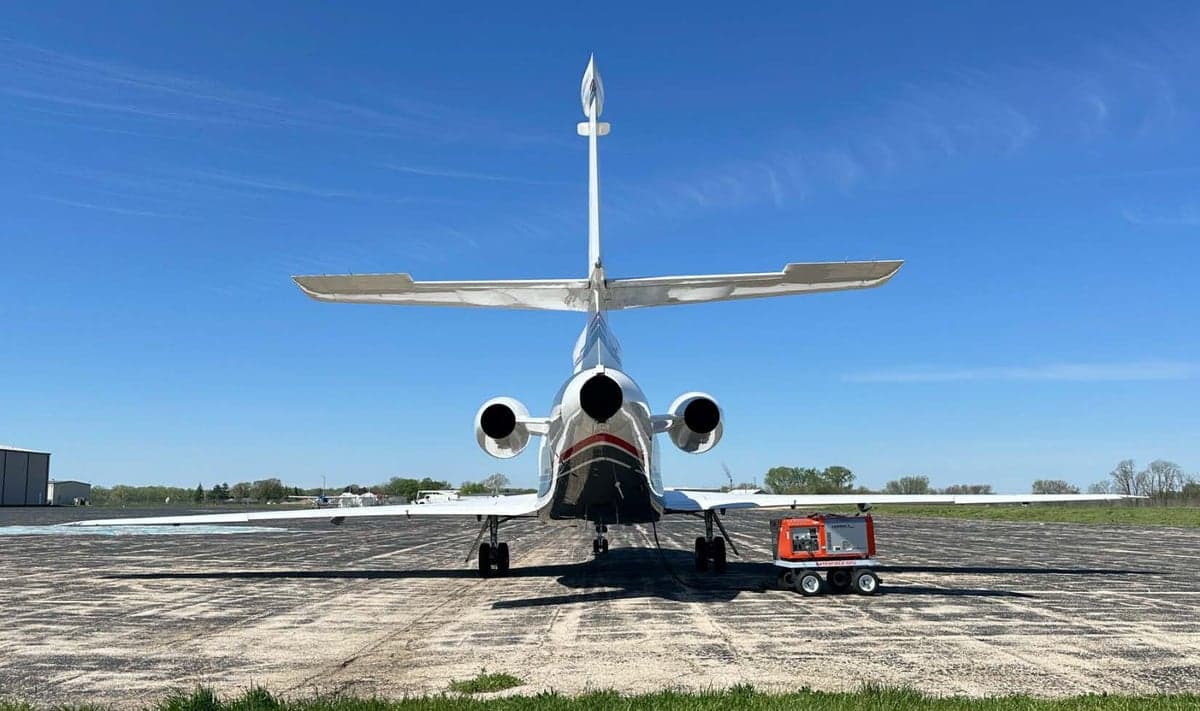 Rear view of the N914TV aircraft parked on the tarmac.