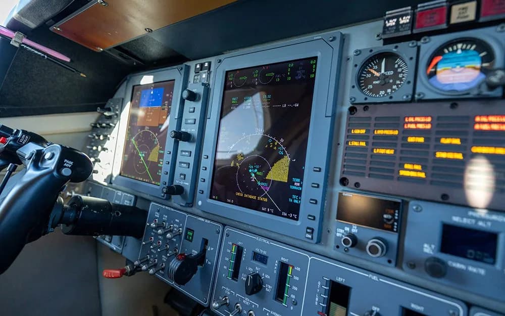 A close-up view of the modern glass cockpit displays and control panel of the aircraft.