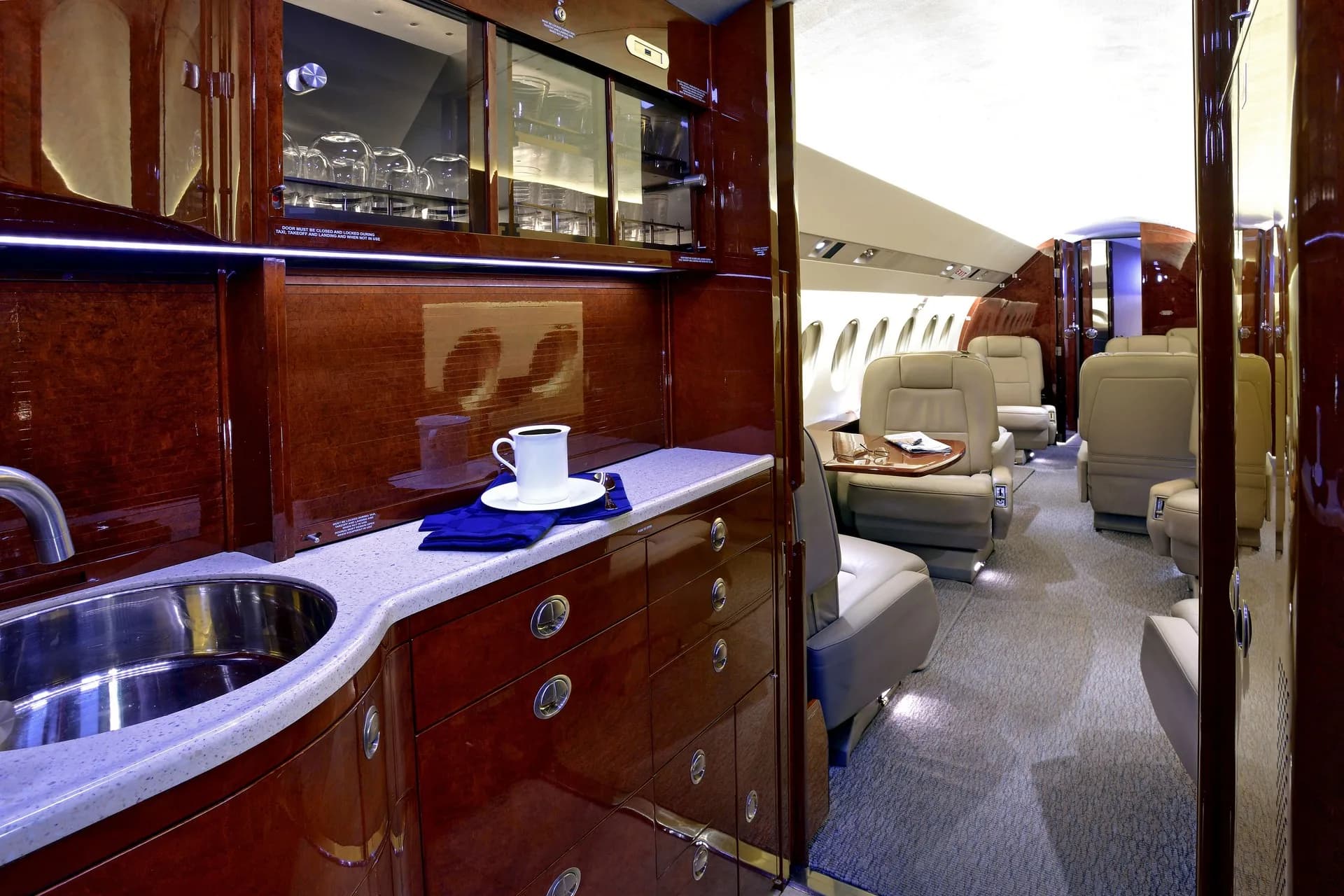 View of the aircraft's galley and cabin with leather seats.