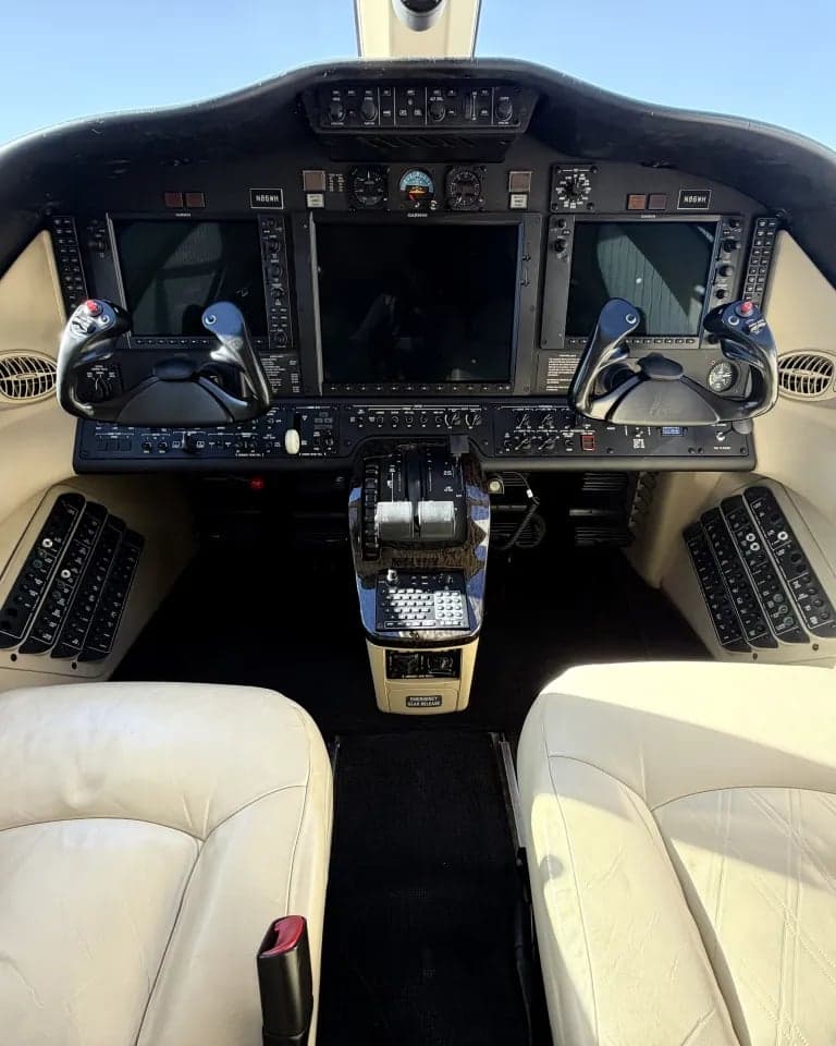 The cockpit of the Citation Mustang, showing the instrument panel and seats.