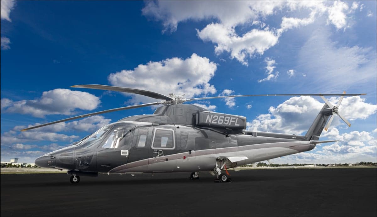 Side view of a gray and silver AgustaWestland AW139 helicopter on the tarmac.