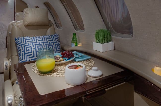 Close-up of the Cessna Citation CJ3+ cabin interior with a table set for a meal.