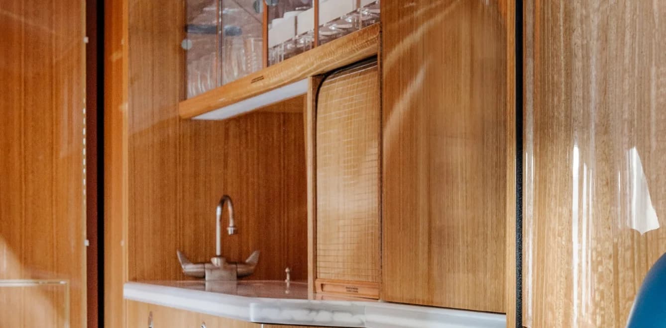 Close-up of the aircraft's interior cabinetry, including a sink and storage.