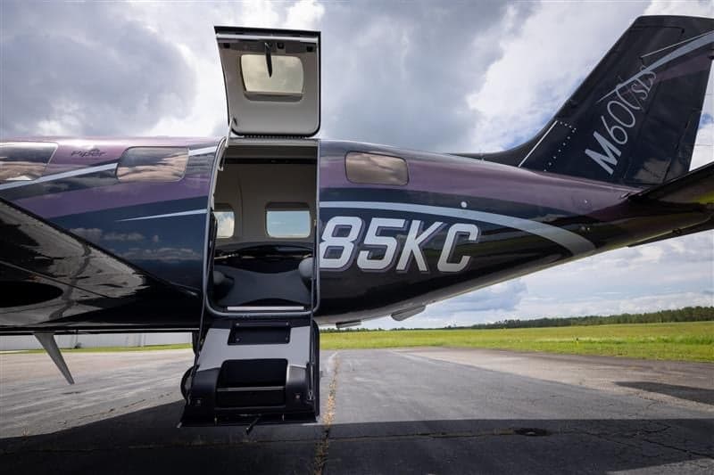 Close up of Piper M600 SLS aircraft N285KC with the door open.