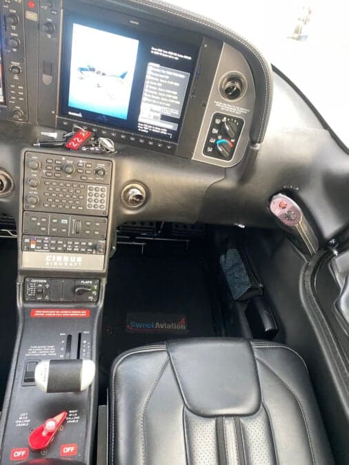 The cockpit of a Cirrus aircraft features a modern avionics suite and comfortable seating.
