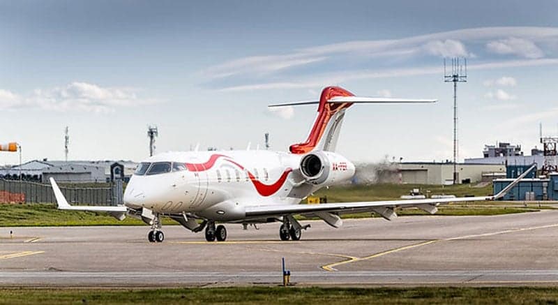 A white and red Bombardier Challenger 350 on the tarmac.
