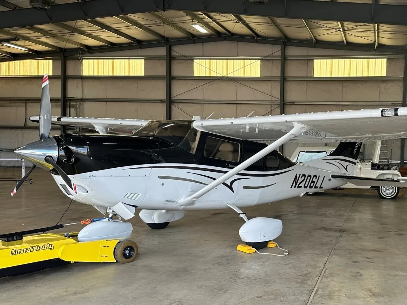 Cessna 206 Stationair aircraft N206LL parked in a hangar.