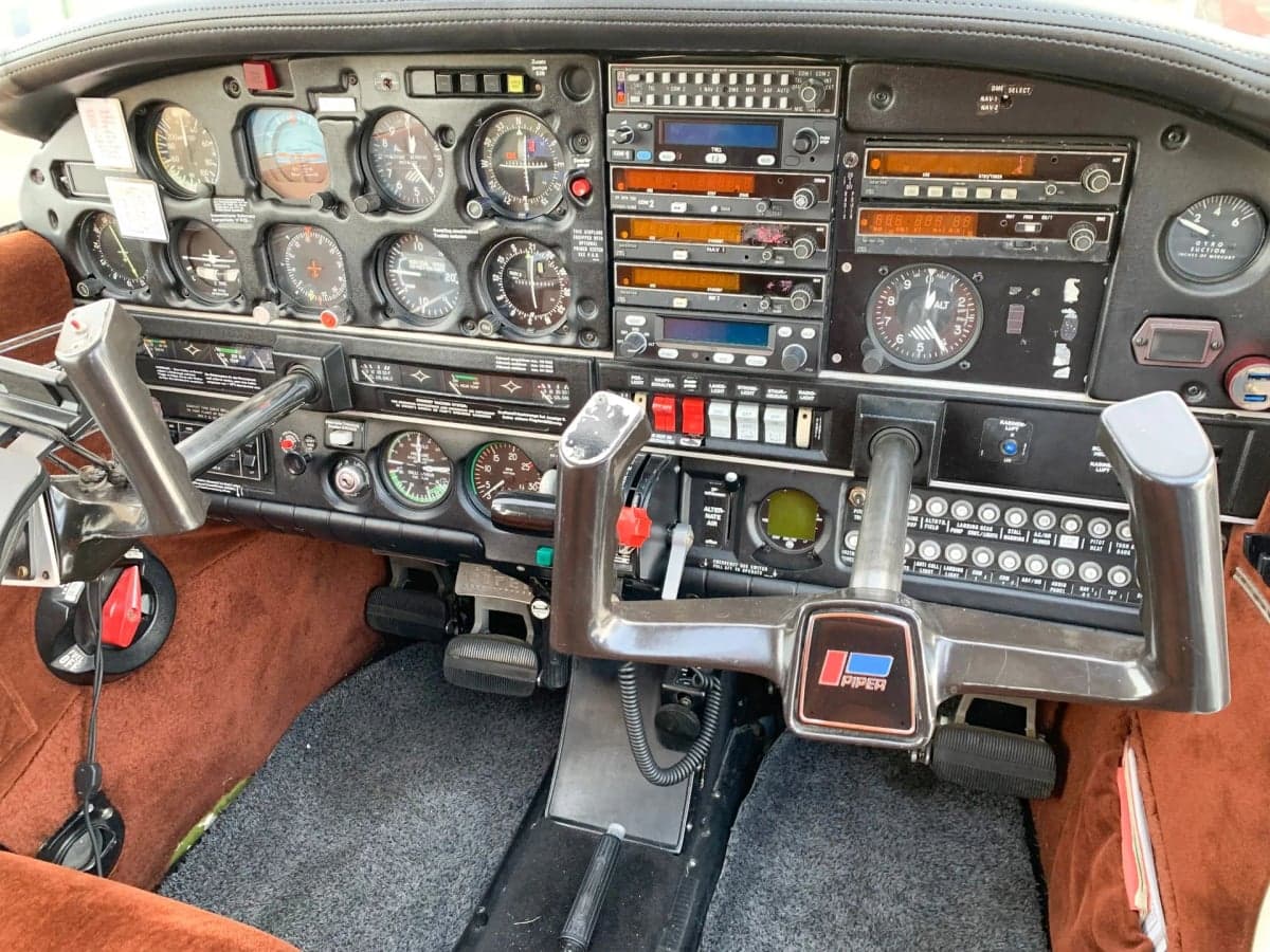 Aircraft cockpit with instrument panel and controls.