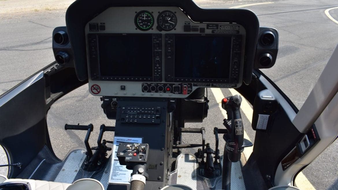 The instrument panel and controls of a helicopter cockpit.