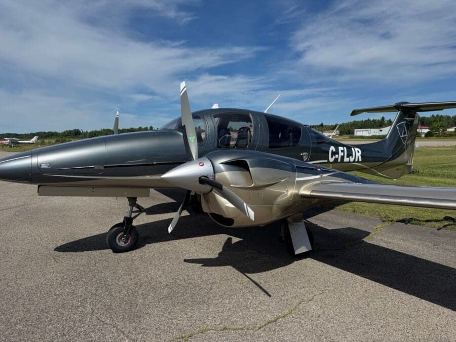 Diamond DA62 aircraft with a gray and gold paint scheme.