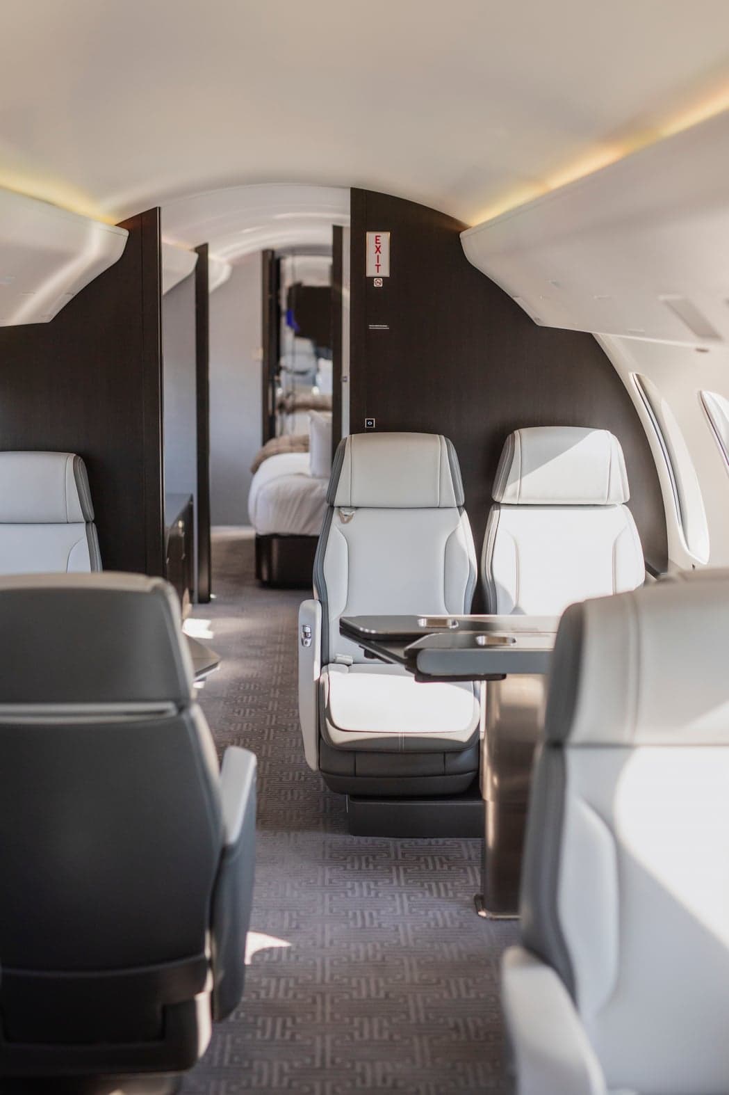 View of the aircraft interior with white leather seats and a table.