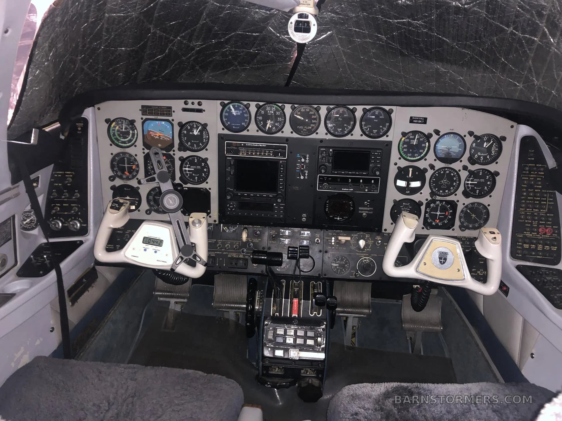 The cockpit features a detailed instrument panel with multiple gauges, two control yokes, and a central throttle quadrant.