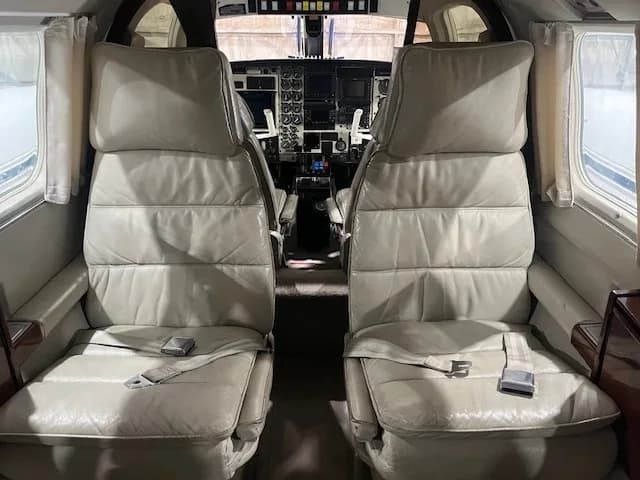 Cockpit view showing the instrument panel and seats.